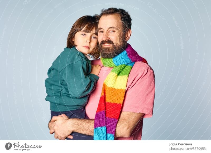 portrait of divorced lgbt father with his daughter in studio on isolated background. happy family relationship parenthood comfort man trust men entertainment