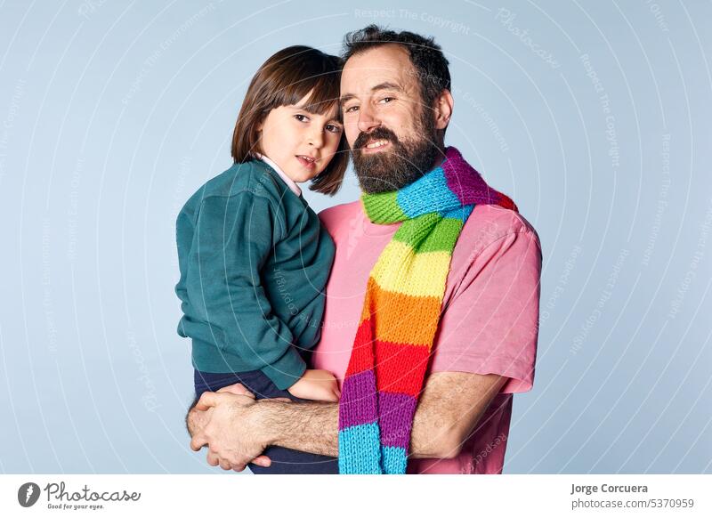 portrait of divorced lgbt father with his daughter in studio on isolated background. happy family relationship couple man together adult love girl child mature