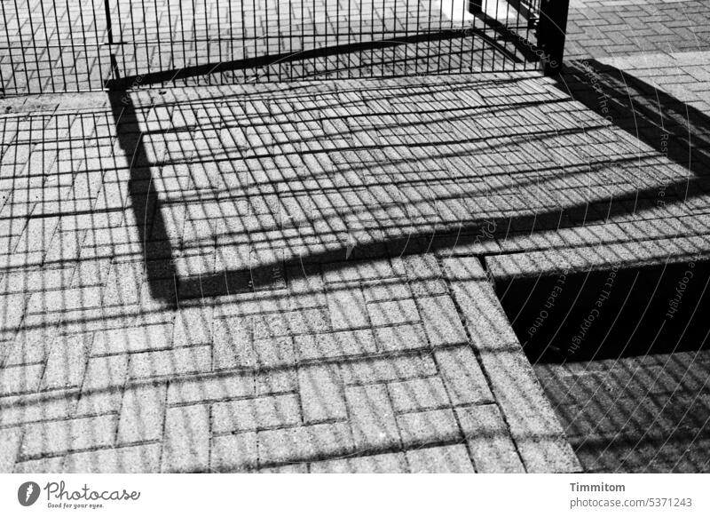 gray in gray | stones, grids and shadows grey in grey Gray Black light and dark lines interstices Paving stone Grating Metal Deserted Black & white photo recess