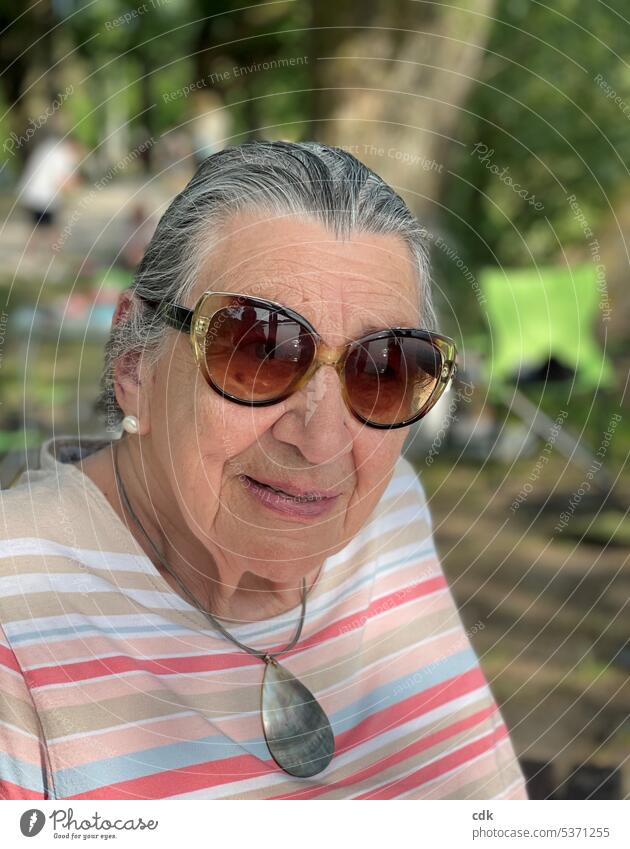 Enjoying the summer at the lake: satisfied senior woman with sunglasses watching the action. Human being Senior citizen Lady Woman portrait Adults Pensioner