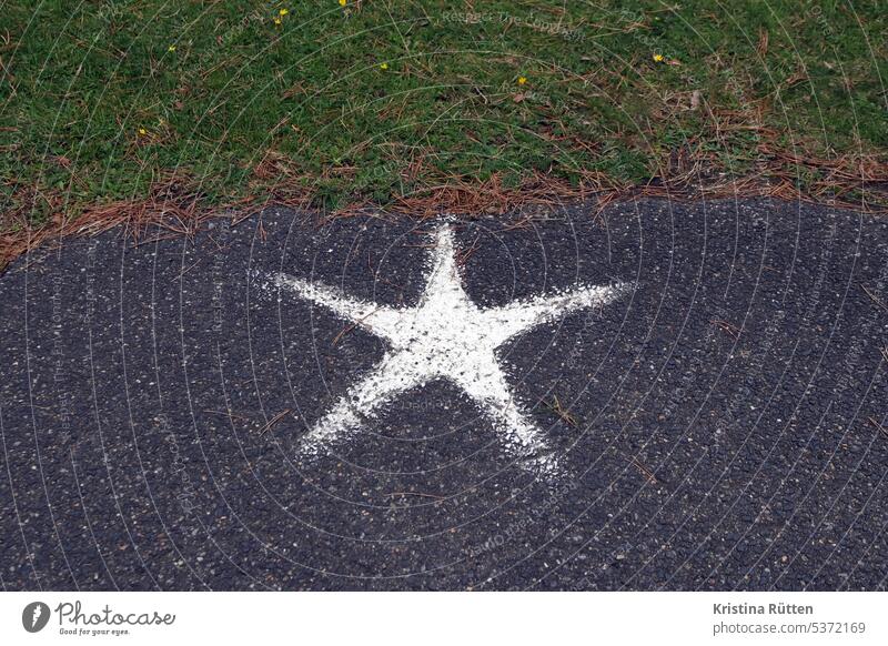 white star on gray asphalt on green lawn Stars five pronged Sign symbol mark label street art Street Ground off Asphalt Lawn Grass