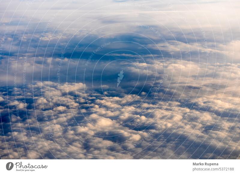 View over clouds from an airplane above clouds cloudscape cloudy flight atmosphere background beauty blue fly freedom heaven high meteorology nature sky space