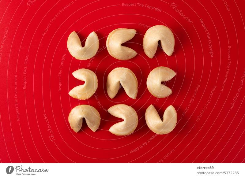 Traditional fortune cookies on red background asian bakery blank chinese closeup concept crispy culture dessert empty food luck message note paper predict snack