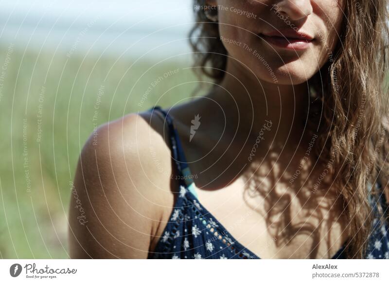 Detail- portrait of young beautiful brunette woman by the sea - dimples, lips, nose and shoulder warm Summery Beautiful weather proximity Day tranquillity