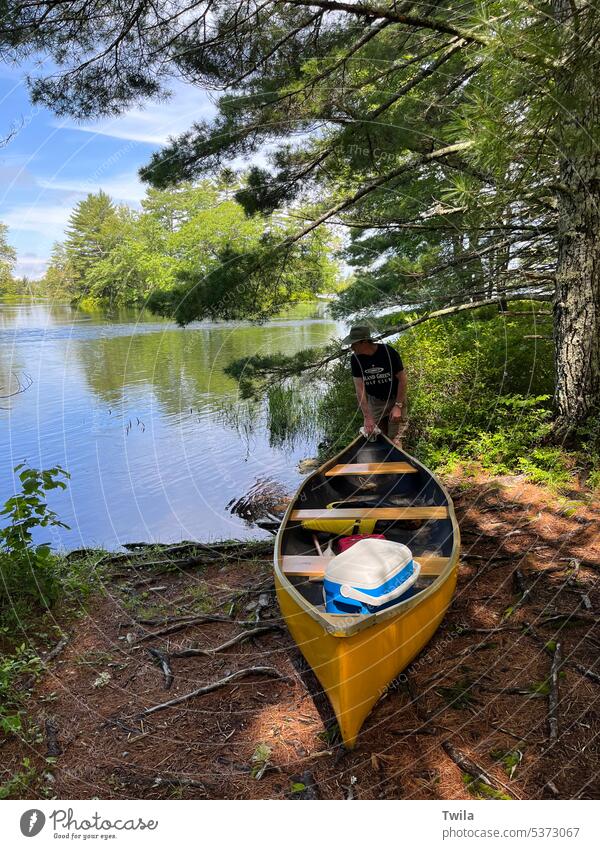 Heading out for a paddle Nature woods forest yellow canoe activity water vacation sport adventure