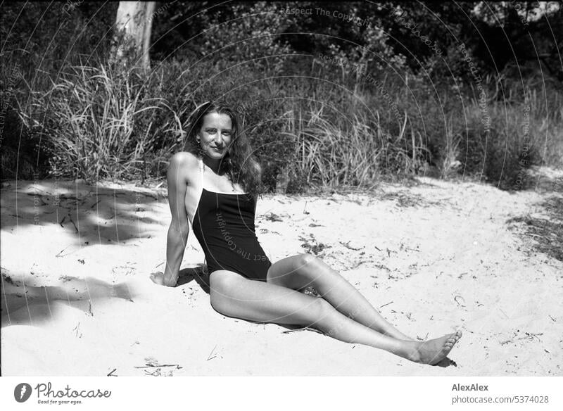 analog black and white side full body portrait of young beautiful woman on beach warm Summery Beautiful weather Day Self-confident Youthfulness Skin