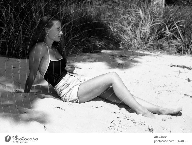 analog black and white side full body portrait of young beautiful woman on beach warm Summery Beautiful weather Day Self-confident Youthfulness Skin
