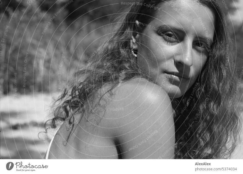 analog black and white side portrait of young beautiful brunette woman with dimples on beach warm Summery Beautiful weather proximity Day Self-confident