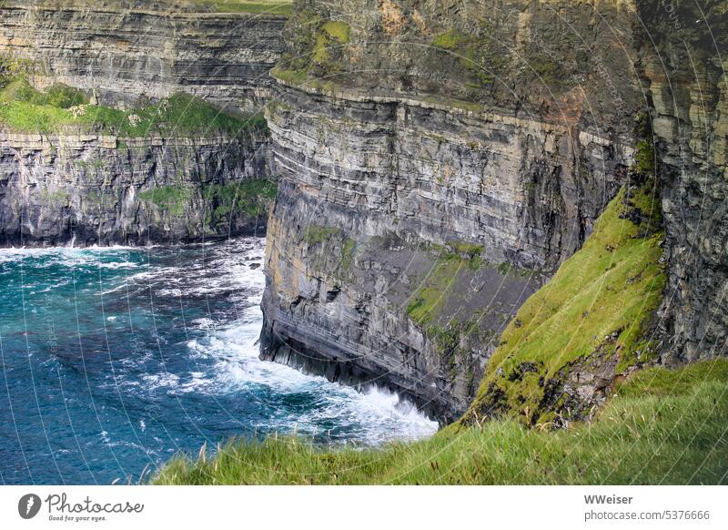 These moss-covered cliffs in the sea are particularly popular with travelers to Ireland Rock Moss stone Ocean Surf Vantage point sunny Light Hiking Torists