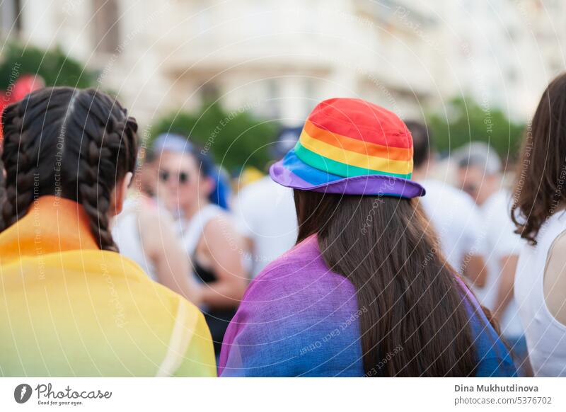 Woman wearing rainbow bucket hat walking at Pride parade. LGBTQ symbol in clothes. rights colorful clothing graphic vector cap template background traditional