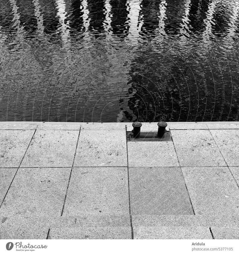 Two small bollards at Jungfernstieg b/w Bollard bank Water small alster reflection Waves Stone slab stagger Hamburg fix Port City Deserted Reflection
