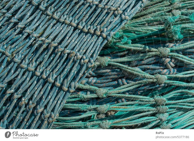Used fishing nets on a pier. Fishing net Net fishnet Fisherman weave craft tangle Rope rope meshes scam Lake Ocean High sea Deep-sea fishermen Commerce Hunting