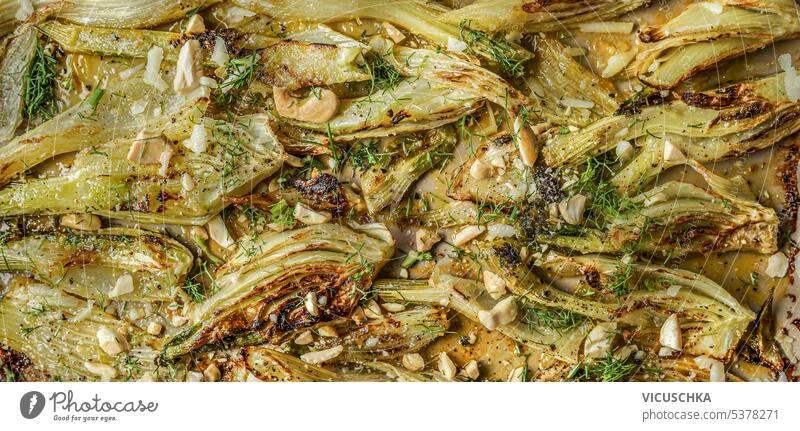 Delicious roasted fennel background with nuts and herbs, top view delicious above vegetable homemade cooked meal sliced food vegetarian tasty