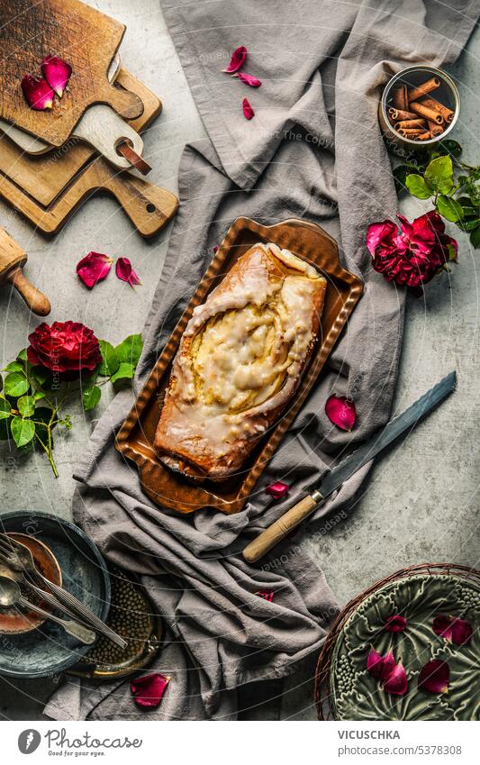 Homemade cheese pie rolls on table with knife, flowers and vintage utensils. Top view homemade top view above pastry baked rustic bakery delicious sweet food
