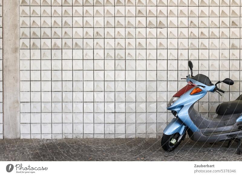 Steel blue motor scooter in front of tiled wall Scooters Blue Iron blue Wall (building) tiles urban Modern Lifestyle City Transport Vehicle Driving Freedom