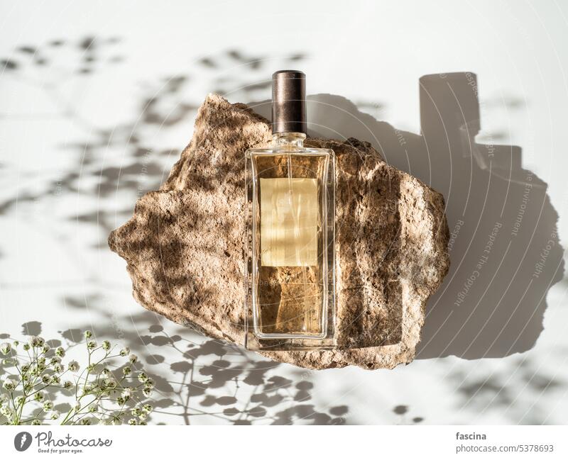 Perfume Bottle on Stone Podium perfume stone geometric shape podium glass bottle design fragrance modern sleek elegant minimalist luxury display aesthetic
