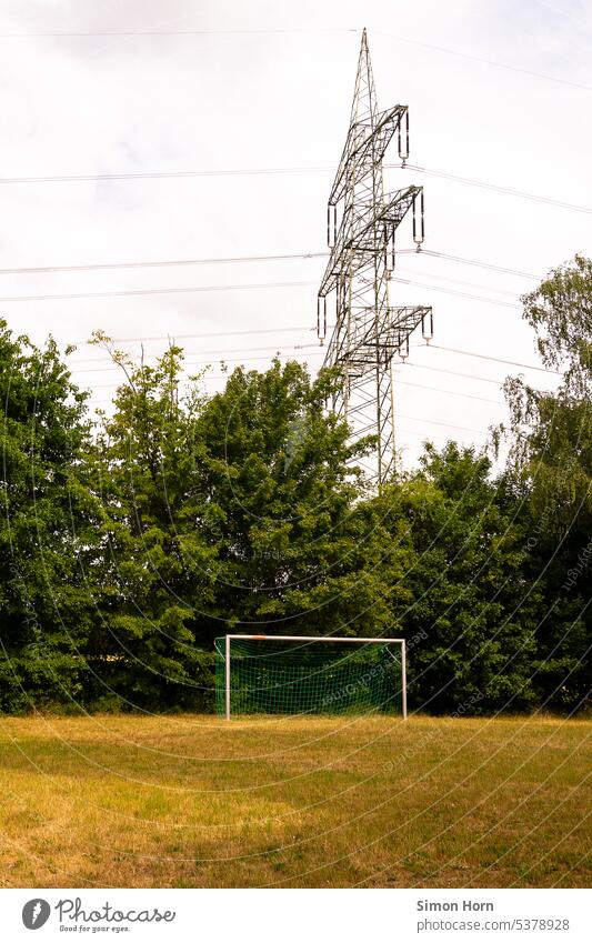 Football field in front of a high voltage pylon amateur football field Infrastructure Electricity pylon Technology short of space space requirements