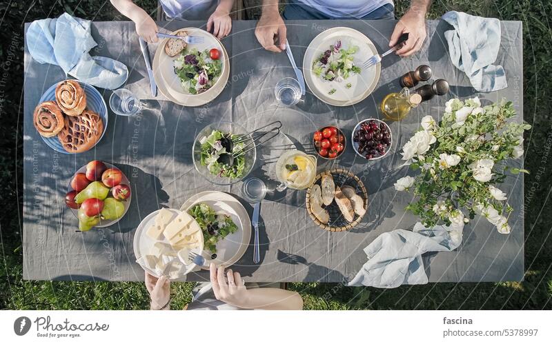 Family dinner outdoors, top view, staycation family aerial aesthetic food organic salad cheese trendy scandinavian style table healthy beautiful summer