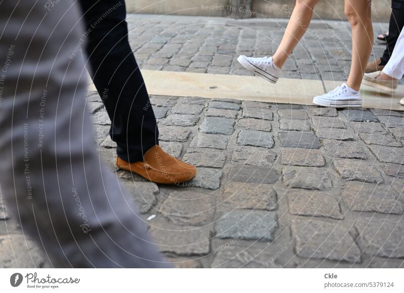 pedestrian Pedestrian Runner Footwear Legs feet off Cobblestones troittor Town encounter barrel Street Lanes & trails Traffic infrastructure Fashion Sidewalk