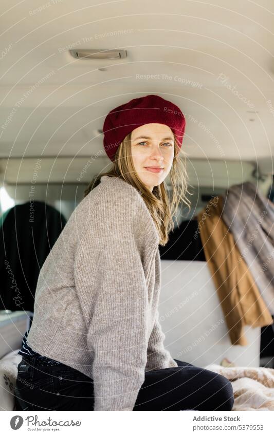 Content woman in beret traveling in camper van traveler car highland mountain trip journey female adventure vacation young nature positive summer vehicle