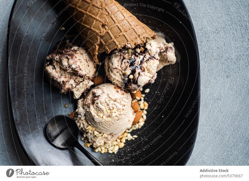 Cone with coffee balls and chocolate ice cream in a bowl almond cold cone delicacy dessert eat food fruit gourmet homemade meal melted nut sweet table scoop