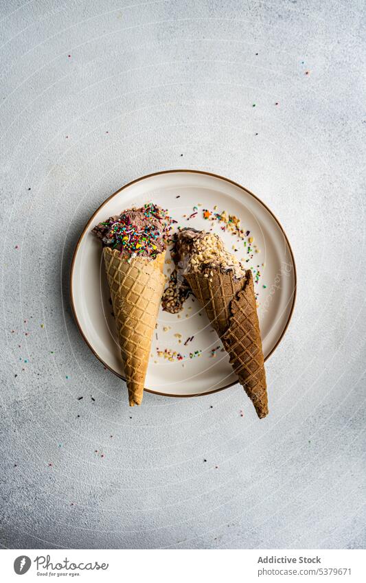 Waffle cones with ice cream almond sprinkle assortment chocolate coffee nuts cold dessert eat food gourmet grey homemade melted multicolored plate sweet