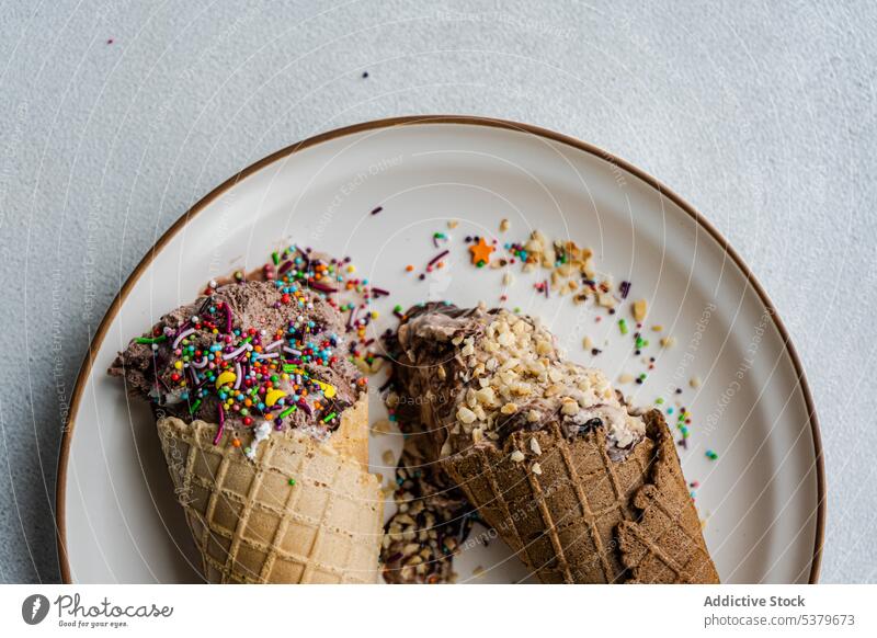 Waffle cones with ice cream almond sprinkle assortment chocolate coffee nuts cold dessert eat food gourmet grey homemade melted multicolored plate sweet