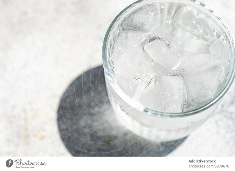 Glass of pure water with ice cold concrete crystal daytime healthy kitchen nutrition organic refresh refreshment minimalist simple stone clear summer drink