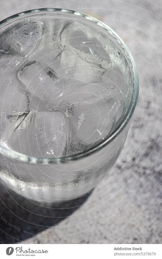 Glass of pure water with ice cold concrete crystal daytime healthy kitchen nutrition organic refresh refreshment minimalist simple stone clear summer drink
