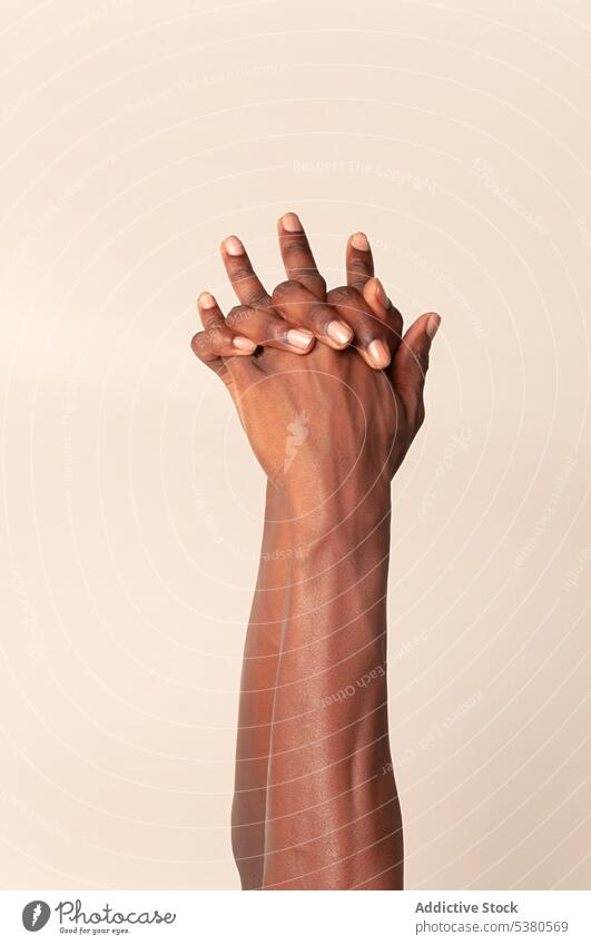 Crop black person holding hands on beige background hand up studio gesture reach out calm symbol tolerance style african american individuality ethnic
