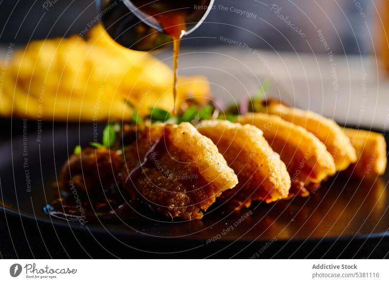 Anonymous cook pouring breaded meat with sauce tasty tradition food food photography culinary dish ecuadorian delicious appetizing cuisine scrumptious portion