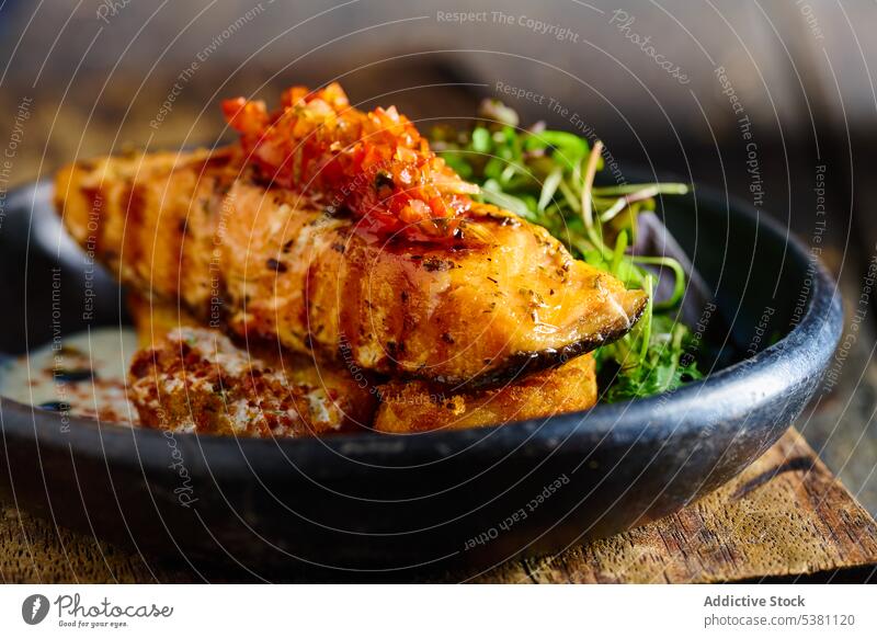 Grilled salmon fillet garnished with herbs grill steak dish delicious sauce appetizing fish seafood ecuadorian restaurant cuisine tasty serve culinary bowl