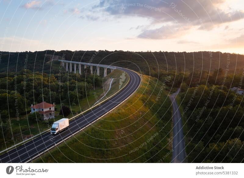 Picturesque drone view of long road bridge infrastructure transport valley forest highway hill landscape route roadway nature tree freeway asphalt construction