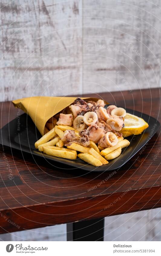 A plate of fried squid with fries, or in Italian: calamari e patate italian food bag eatery lunch tasty nobody background italy genoa europe snack meal dish