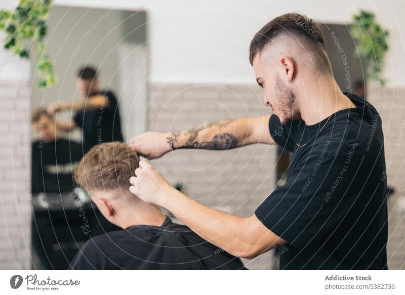 Young barber cutting hair with machine background barbershop beard bearded bearded man beauty blade care client clipping coiffure cutter guy hair salon haircut