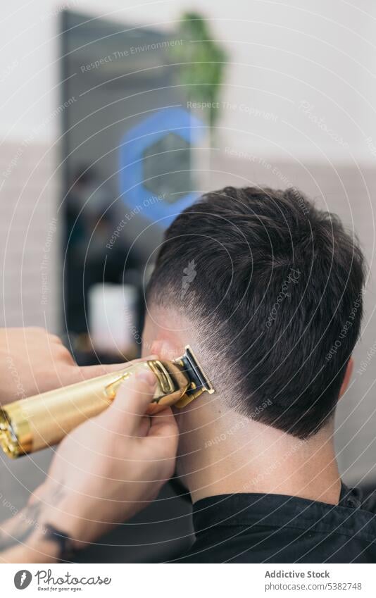 Anonymous young barber cutting hair with machine background barbershop beard bearded bearded man beauty blade care client clipping coiffure cutter gentleman guy