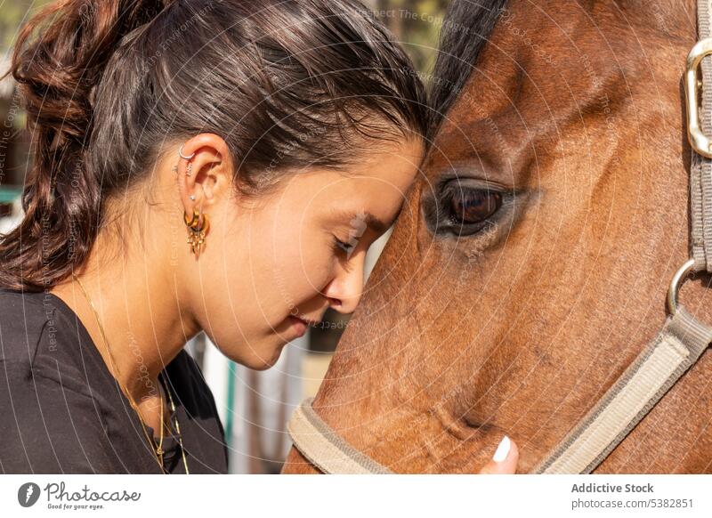 Young woman hugging horse on ranch equestrian countryside animal embrace stable together female farm equine young love stallion horsewoman casual companion