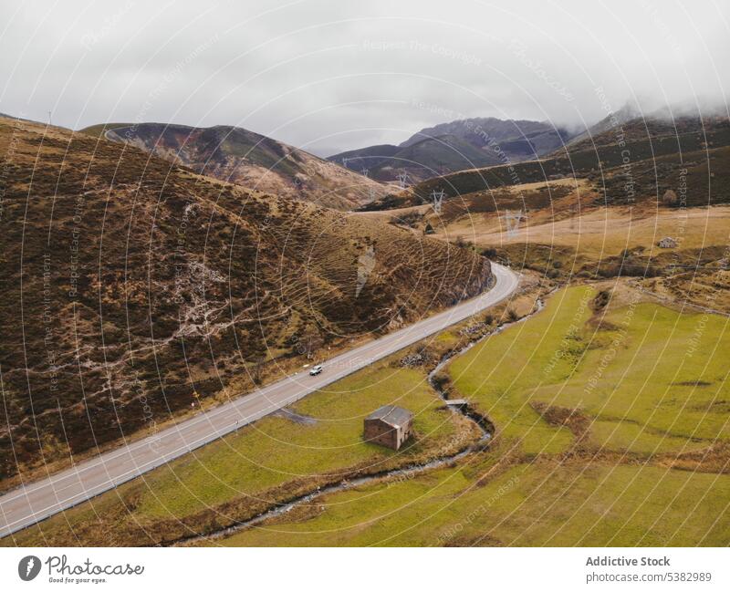 Drone view of asphalt road in hilly area nature mountain countryside highway valley range landscape highland grass spain principality of asturias environment