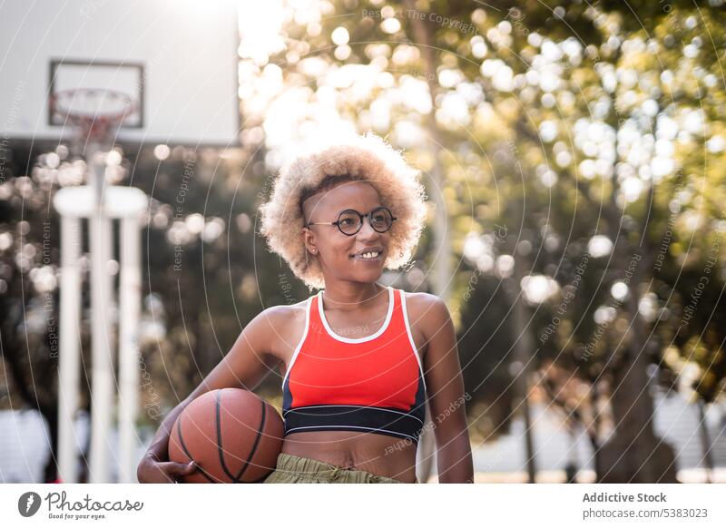 Cheerful black sportswoman with basketball on street player game athlete park young african american female court content lifestyle smile training activity