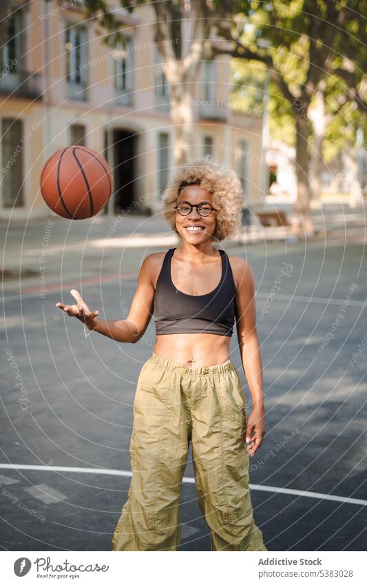 Cheerful black sportswoman with basketball on street cheerful throw player athlete african american young female court game smile happy positive lifestyle
