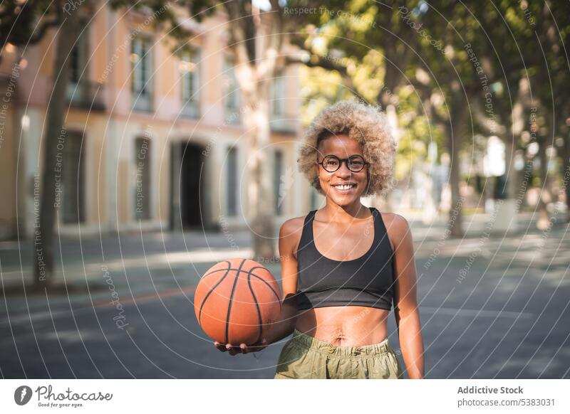 Cheerful black sportswoman with basketball on street cheerful throw player athlete african american young female court game smile happy positive lifestyle