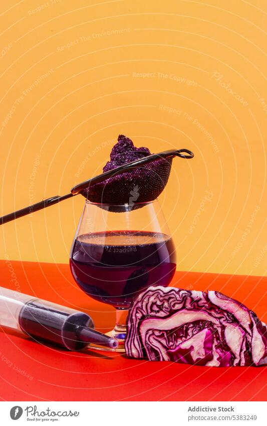 Extracted juice of red cabbage in glass near syringe with cabbage vegan vegetable healthy homemade drink nutrition vitamin vegetarian organic detox natural