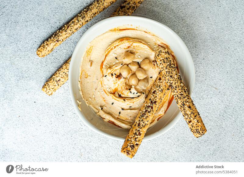 Hummus and bread sticks served in a bowl chickpea cuisine dinner dish food garbanzo gram healthy hebrew hummus israel lunch oil olive organic plant based sesame