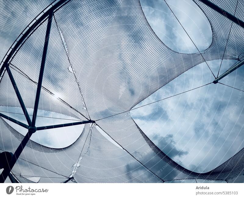 Frog perspective | perforated net in front of blue sky with clouds Net Clouds holes Vista Worm's-eye view Blue sky Exterior shot Light Sunlight Broken Building