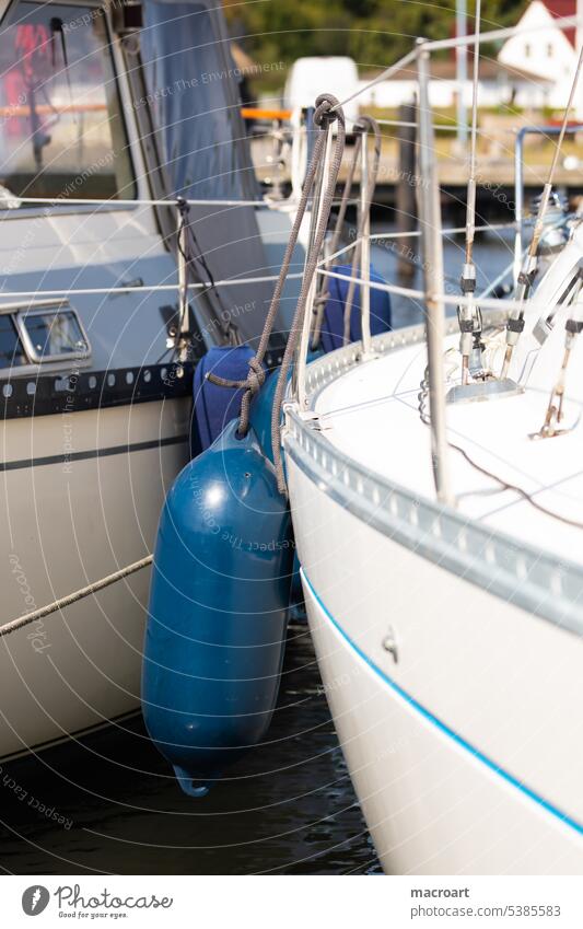 Fenders between 2 boats prevent damage to the outer skin of the boats/vessels Protection parcels ships Impact protection Protection blue Close-up Detail Rope