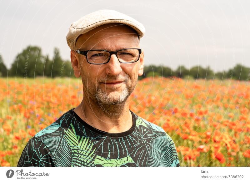 Man in poppy Face Looking into the camera Landscape Poppy Field Adults Human being portrait Designer stubble Eyeglasses Cap