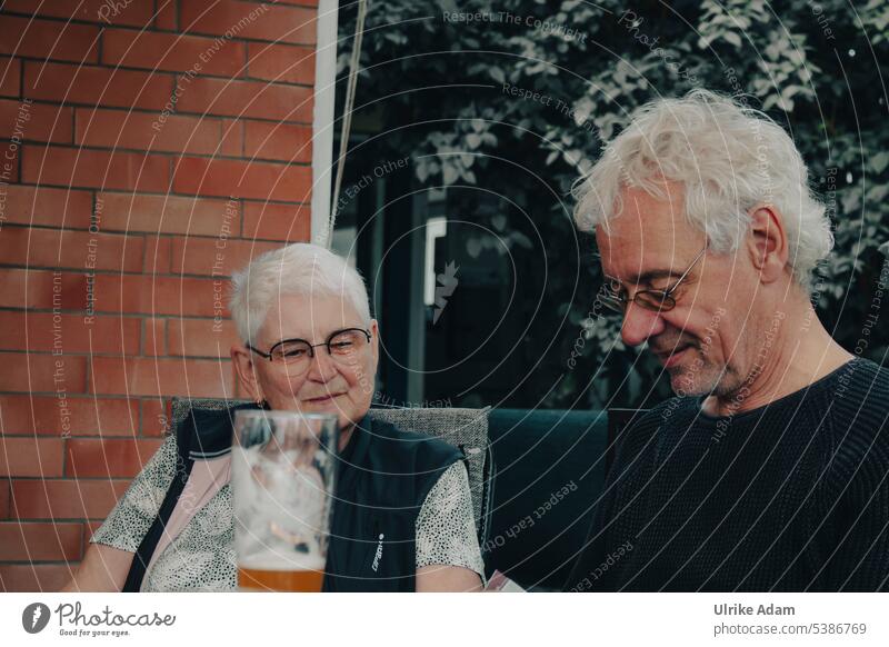 Mainfux | cozy get-together Senior citizen Pensioner grey hair Eyeglasses concentrated smartphone Woman Gray-haired Joy Man Smiling superannuated Retirement