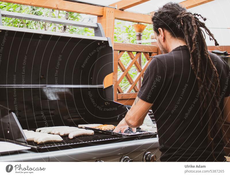 Mainfux | The Grill Master Downward Profile portrait Copy Space right Exterior shot Dreadlocks Braids Long-haired 45 - 60 years Human being Adults Man Masculine