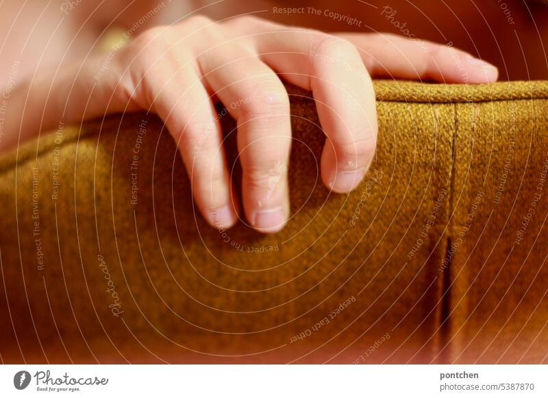 one hand grips a padded chair Chair chair back Grasp Hand Yellow Cloth Design Fingers Colour photo To hold on stop Close-up Touch Interior shot