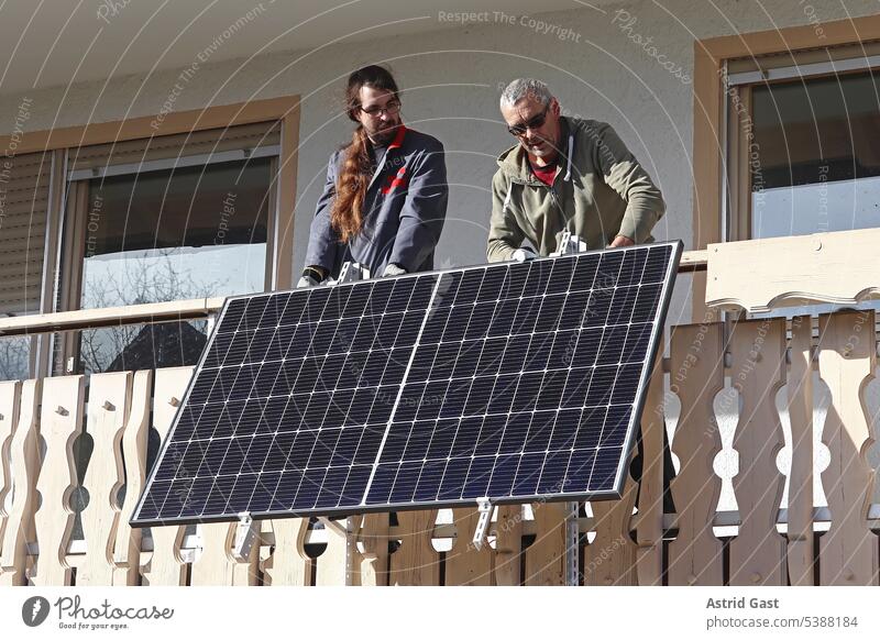 Two men assemble a balcony power plant to generate electricity Balcony power plant solar Power Generation House (Residential Structure) solar modules Modules